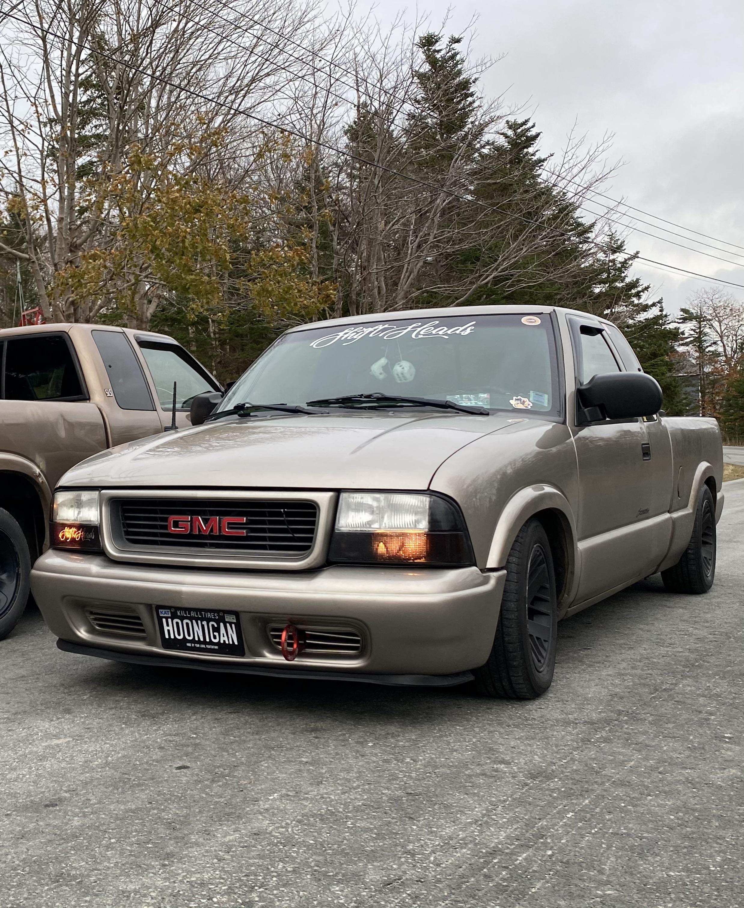 Slammed 2003 GMC Sonoma. Trans am wheels with dumb spacers to make them  work. Full of Japanese stickers. Flush mount tonneau cover. Frame scrapes  on everything. : r/RoastMyCar